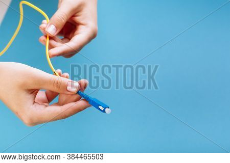 Womans Hands Hold Sc And Fc Connector Fiber Optic Patch Cord Single Mode On Blue Background