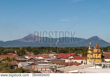 Leon, Nicaragua - November 27, 2008: Cathedral Of Assumption, Asuncion. Smoking Telica Volcano In Di