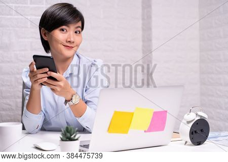 Happy Woman Use Smart Phone At Office