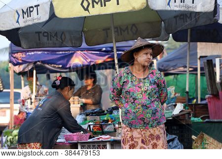 Yangon, Myanmar, Feb 24, 2019: Myanmese Woman With Thanakha (myanmar Powder) On Her Face And Wearing