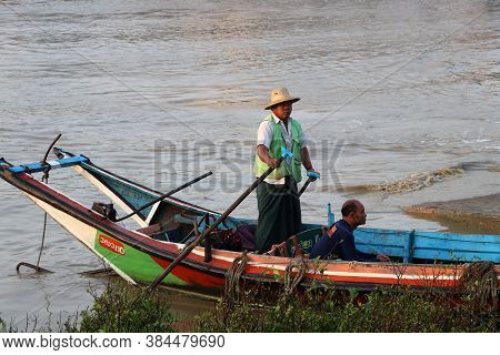 Yangon, Myanmar, Feb 25, 2019: Myanmar Traditional Ferry Driver Rowing To Wait For Passengers Come T