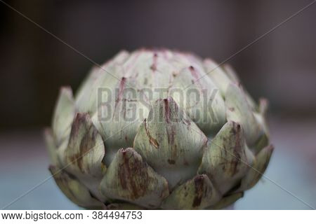 Simple Image Of Artichoke Against Blurred Grey Background With Copyspace