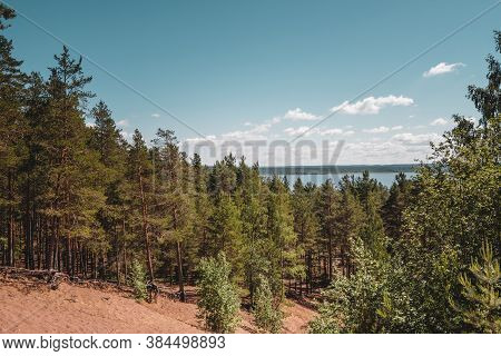 Vuoksa River Near Imatra In The Leningrad Region, Russia. Coastline With Pine Forest Reflected In Vu