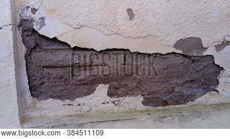 Crack On The Wall Of The House. Old Plaster Falls Off The Surface. Defect During Construction. The E