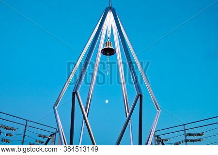 The Bell At Top Of Mt. Moiwa In Sapporo City, Hokkaido, Japan With Night Cityscape Blur Background.