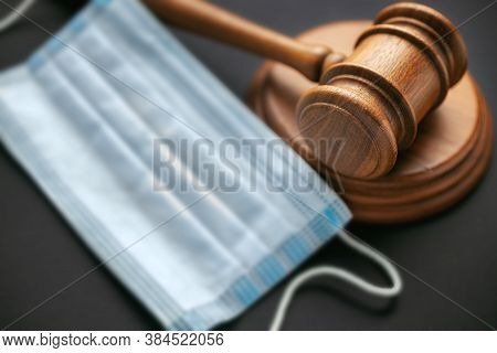 Judge Gavel With Medical Mask On Dark Backgroun Mask Mode Violation Concept