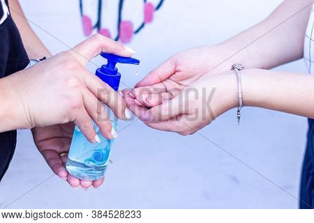 Two Girls Washing Their Hands With Alcogel