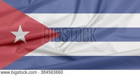 Fabric Flag Of Cuba. Crease Of Cuba Flag Background, Blue And White With The Red Equilateral Triangl