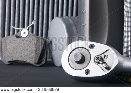 Close-up Of The Switch Button, Spanner, Against The Background Of Consumables For Car Maintenance