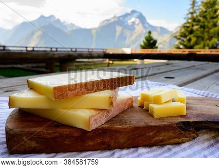 Cheese Collection, French Comte, Beaufort Or Abondance Cow Milk Cheese Served Outdoor With Alps Moun