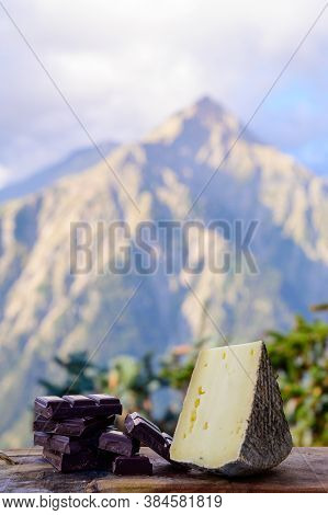 Cheese Collection, French Tomme De Savoie Or Tome Des Bauges Cheese And Dark Chocolate Served Outdoo
