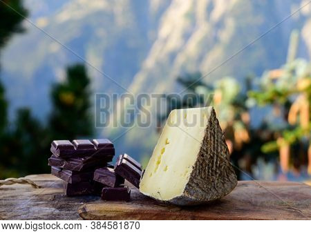 Cheese Collection, French Tomme De Savoie Or Tome Des Bauges Cheese And Dark Chocolate Served Outdoo