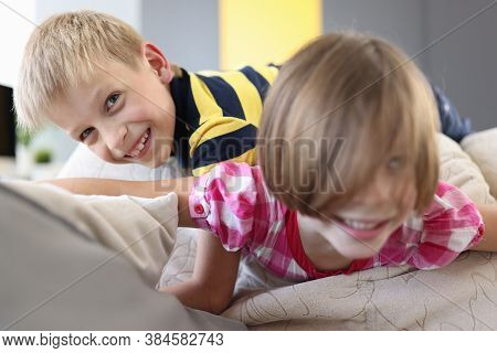 Boy And A Girl On The Couch Are Playing And Laughing. Interesting Outdoor Games For Children Concept