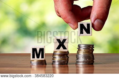 Mxn Mexico Currency Word Symbol - Business Concept. Hands Put Wooden Block On Stacked Increasing Coi