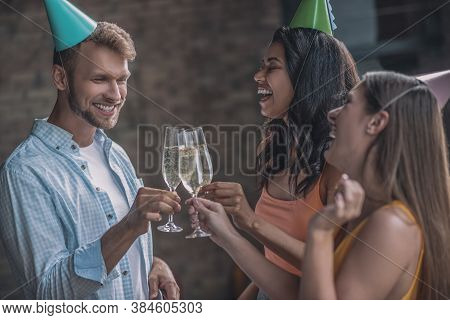 Friends Clanking Their Glasses At The Birthday Party