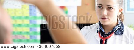 Doctor Looks At Patient Who Drinking From Bottle. Doctor Advises Visiting Doctors Narrow Specialties