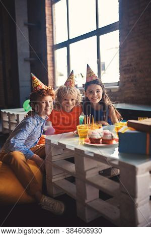 Three Kids Celebrating Bday And Feeling Pleased
