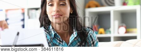Portrait Of Woman Playing Guitar And Looking Carefully At Notes. Smiling Brunette Learning New Tune.