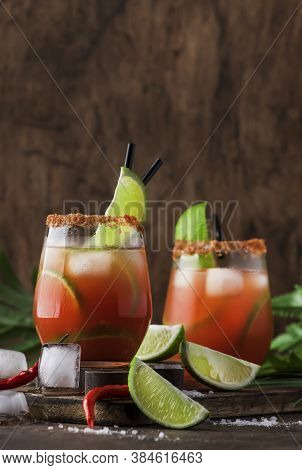 Michelada - Mexican Alcoholic Cocktail With Beer, Lime Juice, Tomato Juice, Spicy Sauce And Spices, 