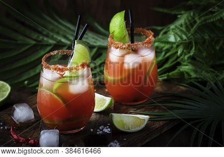 Michelada - Mexican Alcoholic Cocktail With Beer, Lime Juice, Tomato Juice, Spicy Sauce And Spices, 