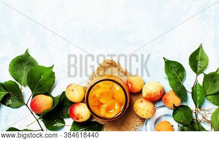 Apricot Confiture In Glass Jar On Blue Background, Top View