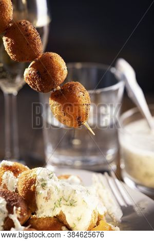 Round Fried Mozzarella Cheese Sticks Under Tzatziki Sauce From Yogurt With Cucumbers And Garlic On S