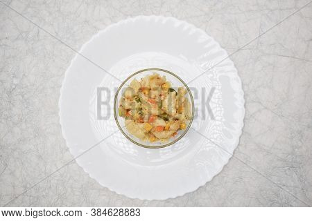 Close Up Of Vegetable Macaroni Cooked In White Sauce Served In A Transparent Bowl Isolated On White 