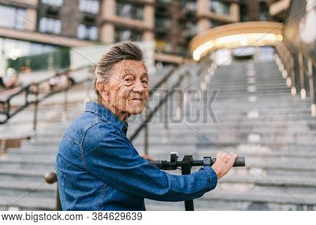 Old Woman Near Scooter. Grandmother Progressive Woman. Senior Having Fun. Old Woman Enjoying Her Hob