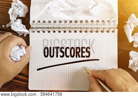 Business And Finance Concept. A Man Writes Text - Outscores In A Notebook . Around A Notepad And Cru