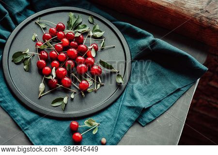 Ripe Cherries On A Black Dish. Cottagecore Aesthetics. Rustic, Vintage Style Juicy Summer Concept