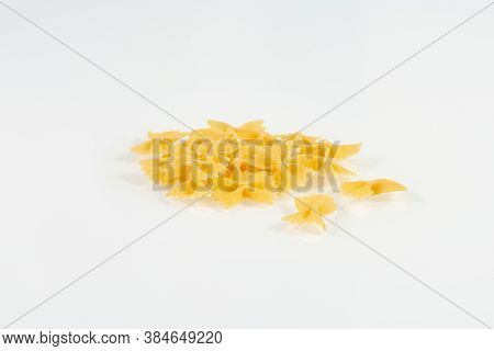 Farfalle Pasta Isolated On White Background. Heap Of Dry Farfalle Pasta. Bow Tie Pasta