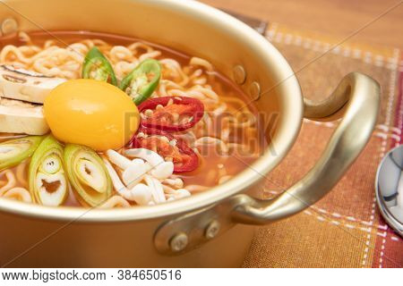 Close Up Image Of Korean Spicy Instant Noodle, Ramyun, With Egg Yolk Inside A Korean Noodle Pot
