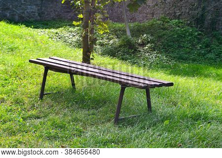 Picture Wooden Benches In The Grass Under A Tree Offering A Moment Of Rest While Exploring The Castl