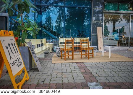 Gangseo,south Korea-august 2019: Bench And Chairs In Front Of A Coffee Shop With Wooden Sign Board