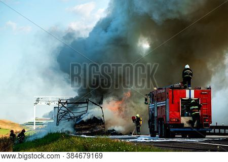 Firefighters Put Out The Fire With Foam In The Car, Fire Engine Extinguishes A Fire On The Road