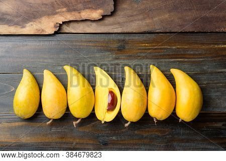 Eggfruit Or Canistel On Wooden Table, Thai Fruit, In Thai Names Such As Xiantao, Lamut Khamen Or Mon