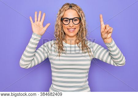 Beautiful blonde woman wearing casual striped t-shirt and glasses over purple background showing and pointing up with fingers number six while smiling confident and happy.