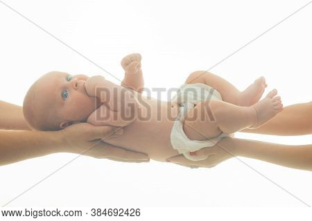 Loving Family And Childhood Concept. Infant Held By Hands Of Both Parents On White Background.