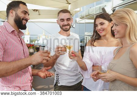 Two Couples On Double Date At Rooftop Bar