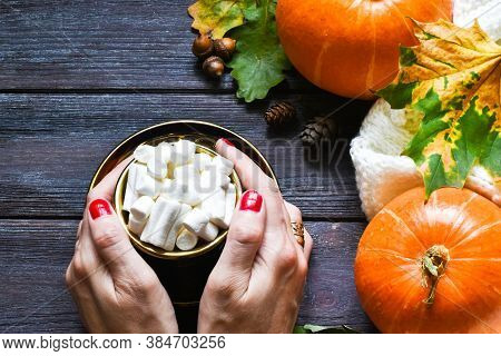 Autumn Sweet Hot Drink. Female Hand Holding Traditional Latte Cup In Hands, On Rustic Wooden Backgro