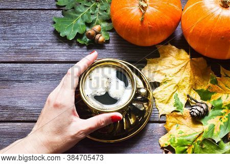 Autumn Sweet Hot Drink. Female Hand Holding Traditional Latte Cup In Hands, On Rustic Wooden Backgro