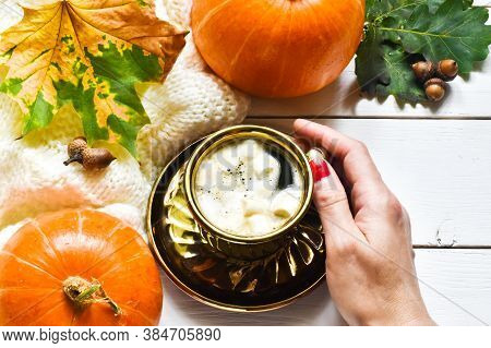 Autumn Sweet Hot Drink.composition With Female Hand Holding Cup Of Pumpkin Latte With Marshmallow,  