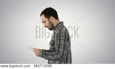 Tablet Computer Side View Of Man Using Digital Tablet On Gradien