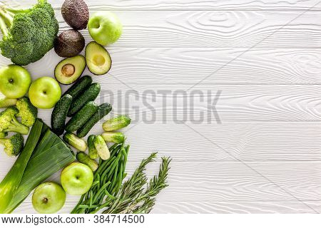 Green Vegetables Background. Сucumber, Avocado, Broccoli, Beans, Leek And Fresh Apple On White Woode