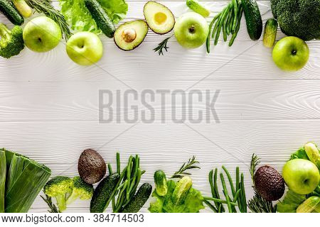 Green Vegetables Background. Сucumber, Avocado, Broccoli, Beans, Leek And Fresh Apple On White Woode