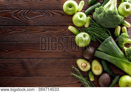Green Vegetables Background. Сucumber, Avocado, Broccoli, Beans, Leek And Fresh Apple On Dark Wooden
