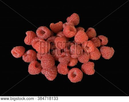 Background Texture: Red Raspberries On A Black Background. Ripe Raspberries, Close-up.