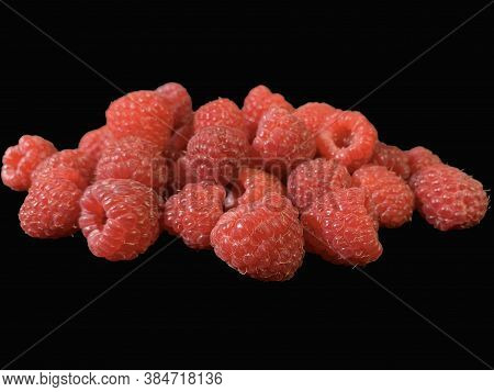Background Texture: Red Raspberries On A Black Background. Ripe Raspberries, Close-up.