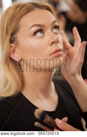 Vertical Shot Of A Gorgeous Woman Getting Professional Makeup Done By Makeup Artist