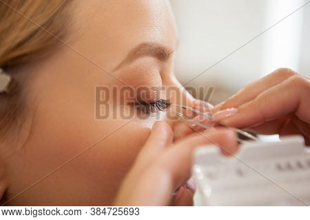Cropped Closeup Of A Professional Makeup Artist Applying False Lashes On The Eyes Of A Woman
